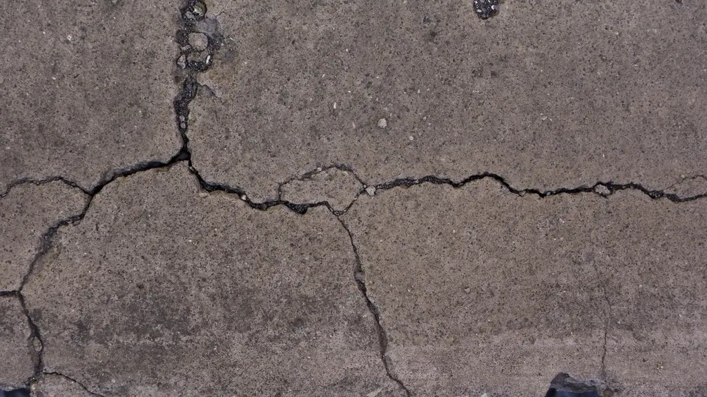 Close-up of a crack running across a concrete surface